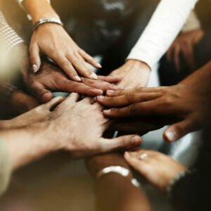 Closeup of diverse people joining their hands